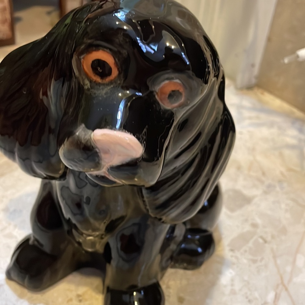 black ceramic dog that shows signs of being well